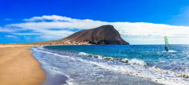 Beaches and water activities in Tenerife. La Tejita beach (el Medano) clipart
