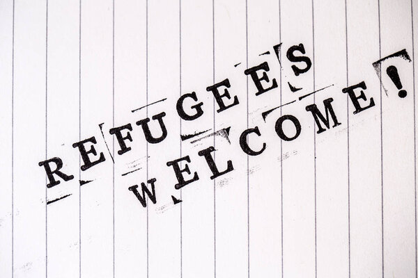 refugees welcome text on paper