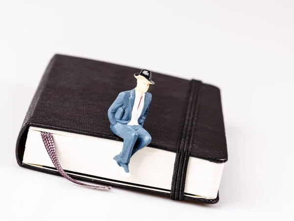 Model of man sitting on organizer or planner — Stock Photo, Image