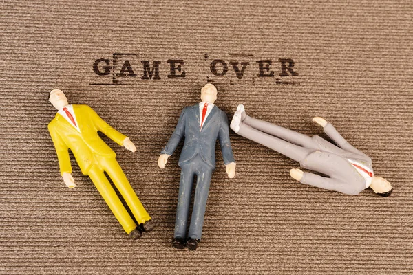 Text game over with human bodies — Stock Photo, Image