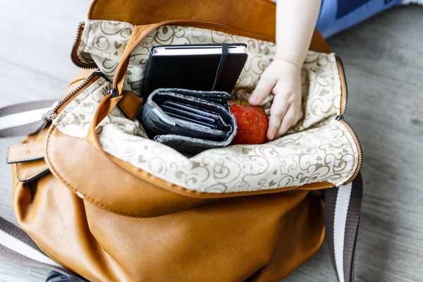 Inside woman handbag on the wooden floor — Stock Photo, Image