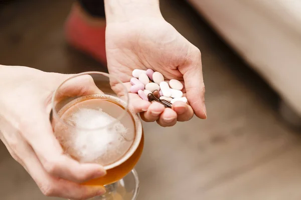 Problema adicto, mujer con pastillas y cerveza en las manos . — Foto de Stock