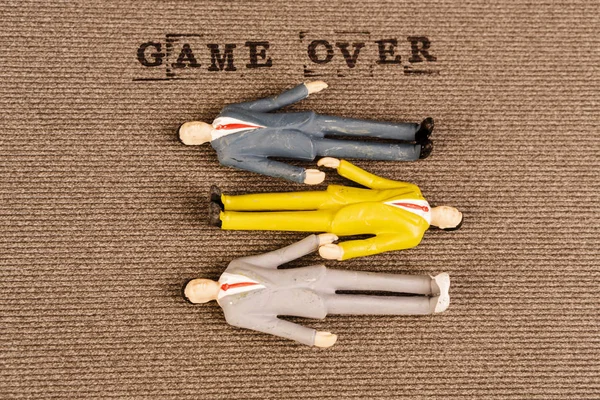 Text game over with human bodies — Stock Photo, Image