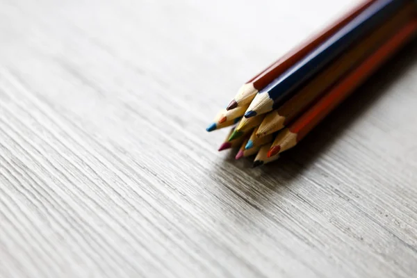 Pack of color pencils or pastel on wooden floor — Stock Photo, Image