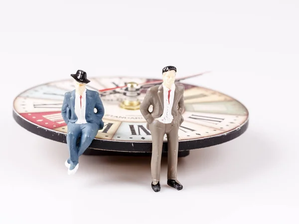 Model of man sitting on beautiful old clock — Stock Photo, Image