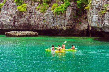 Ang Thong Deniz Parkı, Samui, Tayland - 13 Ekim 2019: Idyllic turkuaz okyanusunda kayak yapan turistler, Ang Thong Ulusal Deniz Parkı 'ndaki yeşil orman ağaçları ve kireç taşı dağlarıyla adanın yakınını keşfetmek için.