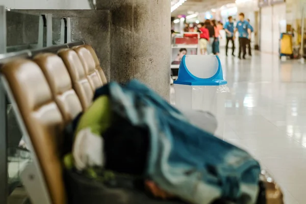 Blue cover transparent trashcan for increasing safety measures placed on the floor in the airport.