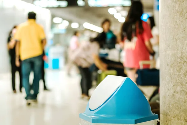 Blue cover transparent trashcan for increasing safety measures placed on the floor in the airport.