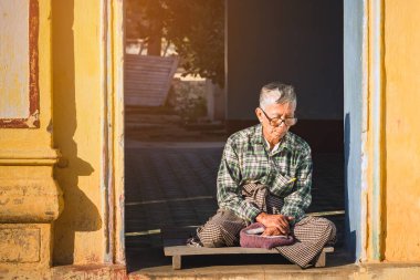 PAGAN-Myanmar, 21 Ocak 2019: Tanımlanamayan insanlar Shwezigon Pagoda 'da Budist yazıtları ile 21 Ocak 2019' da Pagan, Myanmar 'da meditasyon yapıyor ve dua ediyorlar..