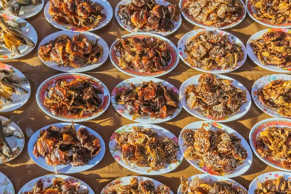 Many kinds of deep fried fish on dish for sale at street food in Thailand.