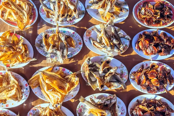 Many kinds of deep fried fish on dish for sale at street food in Thailand.