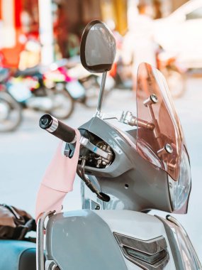 Şehirdeki yol kenarındaki mikropları önlemek için motosiklet sapına asılan bir maske. Corona virüs koruma kavramı.