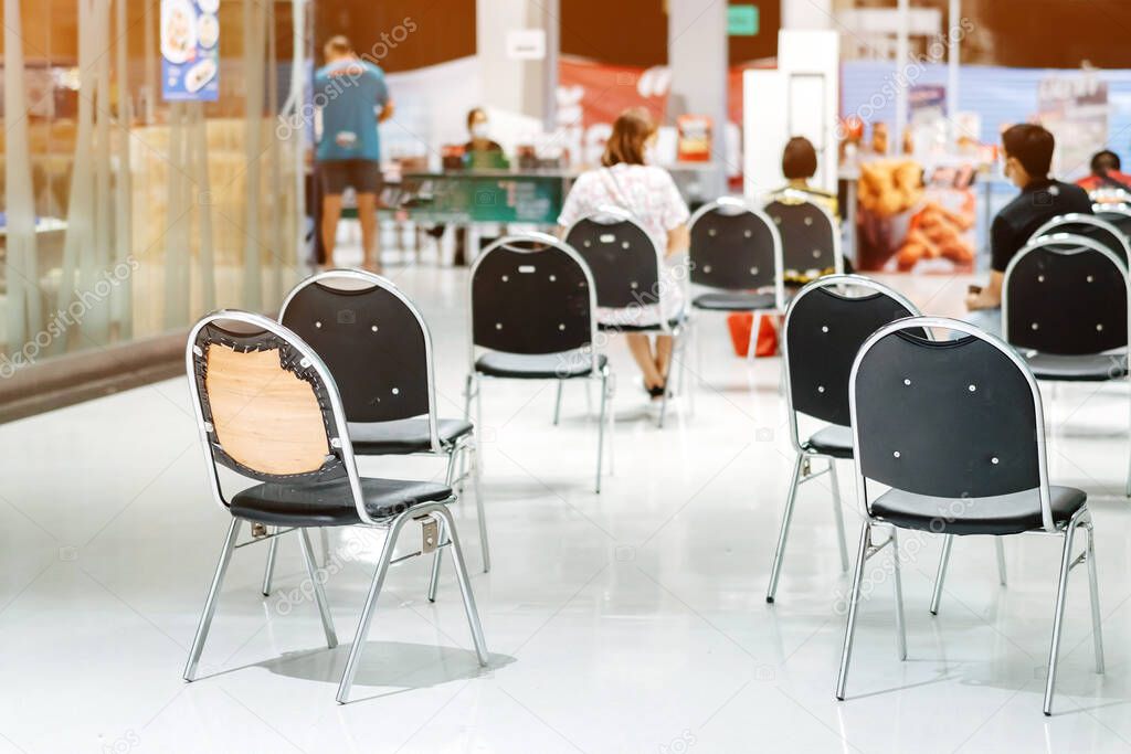 Many chairs for customers to order food and wait to take home inside of department store closed due to the corona virus (Covid-19). Restaurants set chairs for waiting for the food. Selective focus.