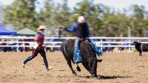 Cowboy Riding Bull At Rodeo