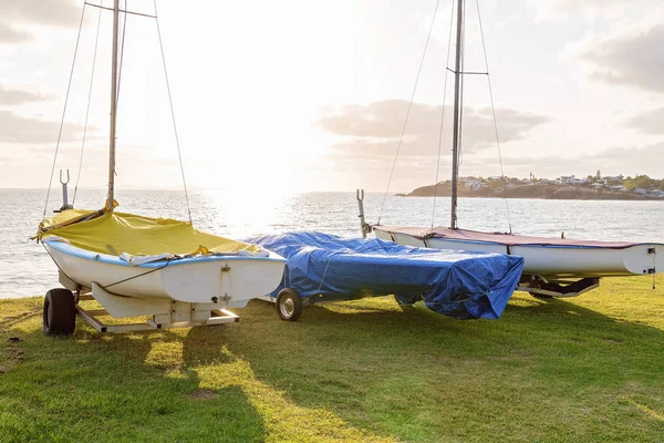 Early Morning Sunlight Shining Across The Ocean Onto Parked Sail Boats — Stock Photo, Image