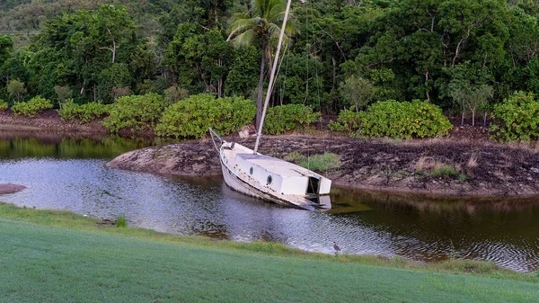 A sunken yacht in a small lake now used as landscape decoration