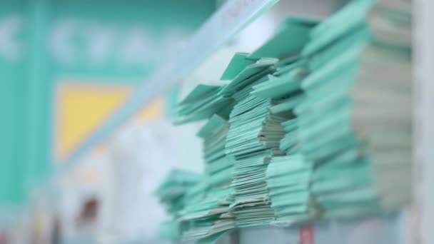 Fingers on a stack of thin notebooks — Stock Video