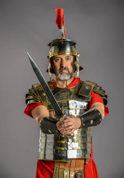 Romeinse Soldaat Met Een Scherp Zwaard Geïsoleerd Een Grijze Achtergrond — Stockfoto