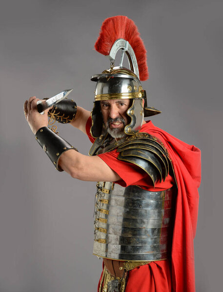 Roman Soldier holding a sword isolated on a gray background