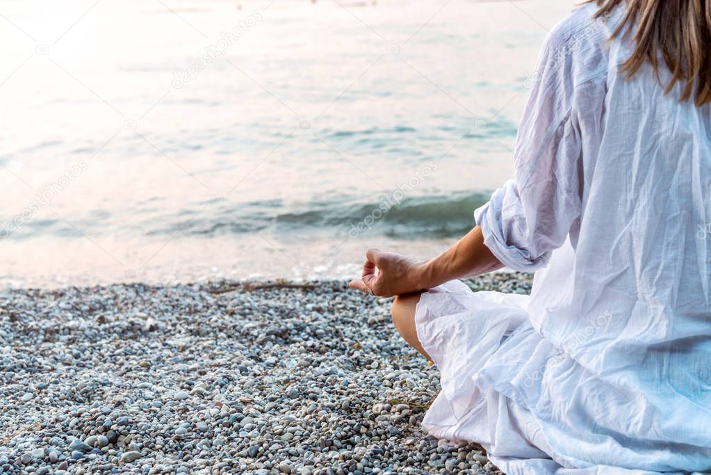 Woman meditating at the sea