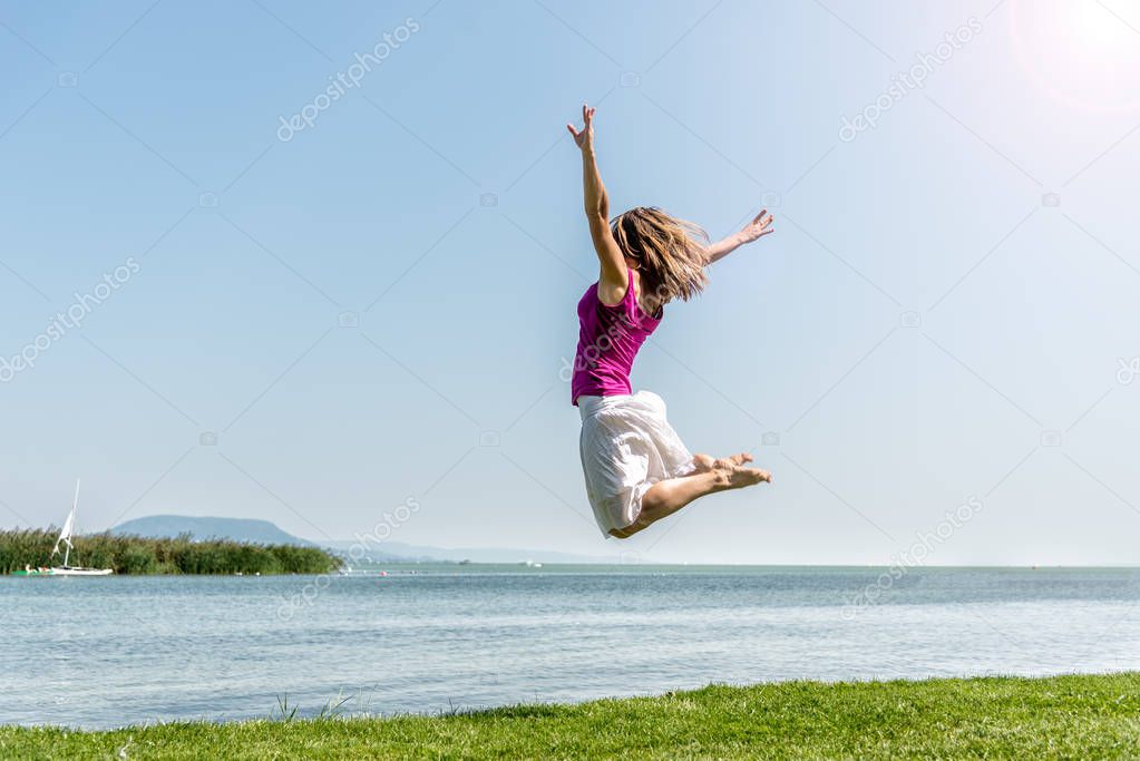 Girl jumping on the lake