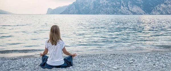 Mujer meditando en el lago —  Fotos de Stock