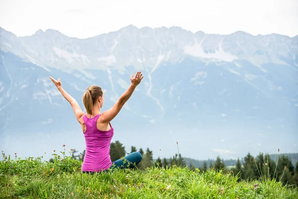 Giovane donna meditare in cima alla montagna — Foto Stock