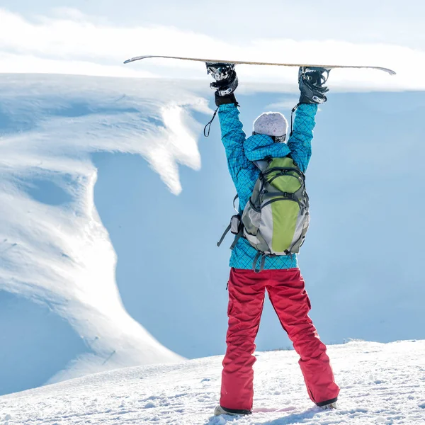 Snowboarderin steht mit Snowboard, — Stockfoto
