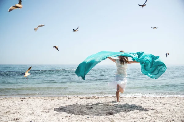 Beautiful girl running on the sea — Stock Photo, Image