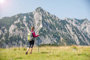 Dağlarda yürüyüş yapan genç bir kadın.