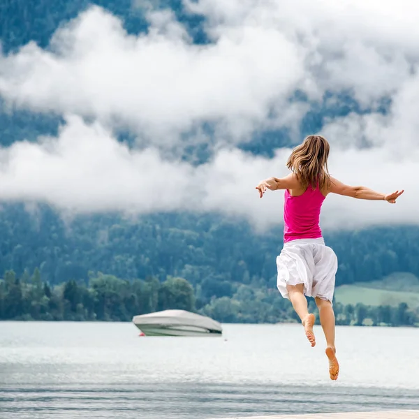 Woman jumping at the lake — Stock Photo, Image