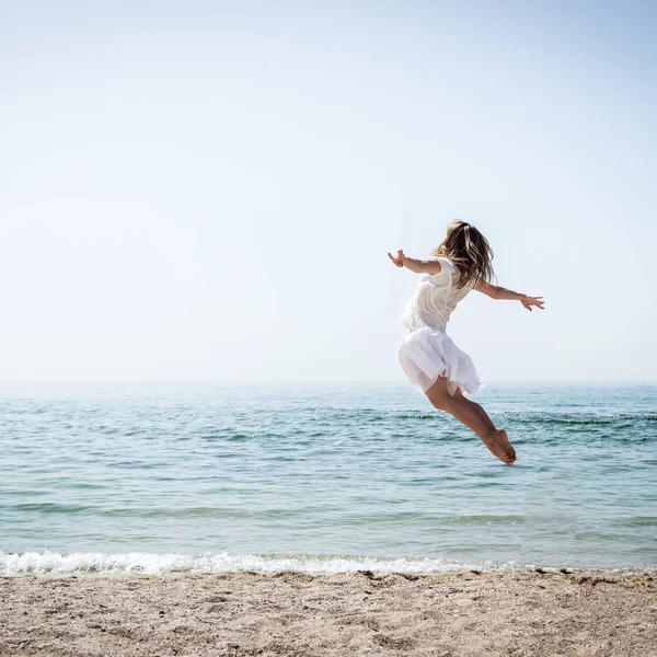 Ευτυχής όμορφη νεαρή κοπέλα πηδώντας — Φωτογραφία Αρχείου