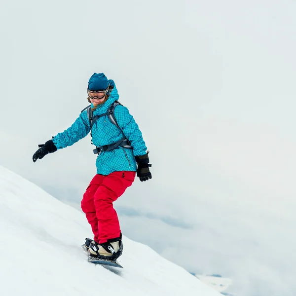 Junge Frau auf dem Snowboard — Stockfoto