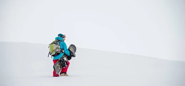 Young woman on the snowboard — Stock Photo, Image