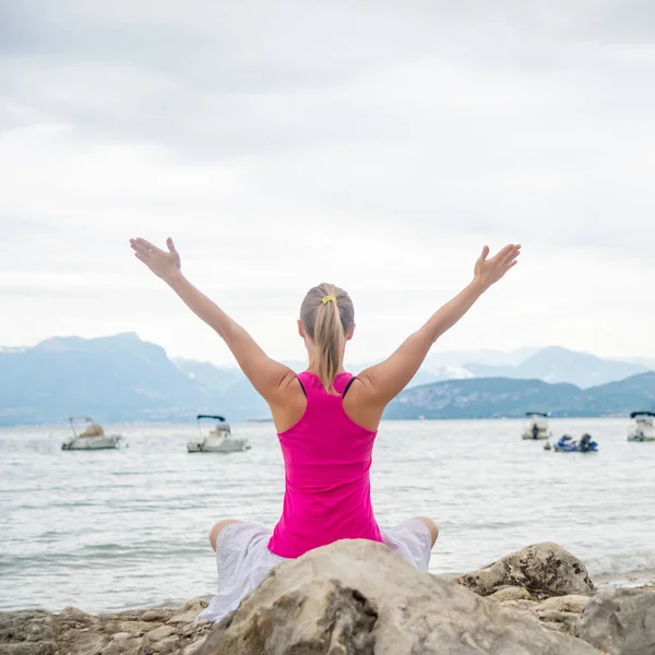 Frau meditiert am See — Stockfoto