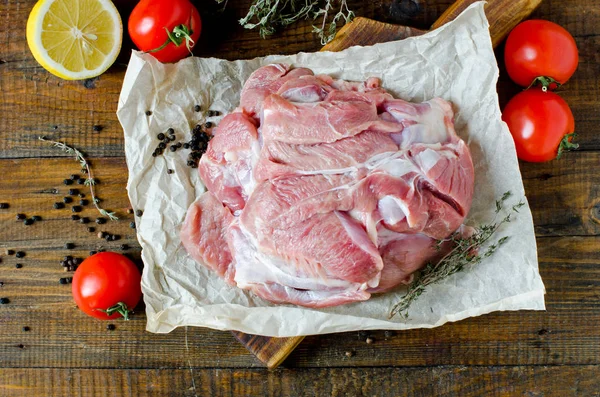 Raw turkey thigh fillets on a wooden table