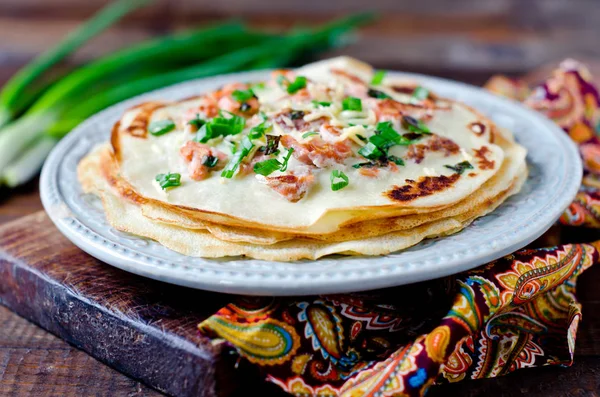 Pancakes with fish, cheese and green onions — Stock Photo, Image