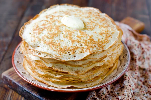 Yeast pancakes with butter on a plate — Stock Photo, Image