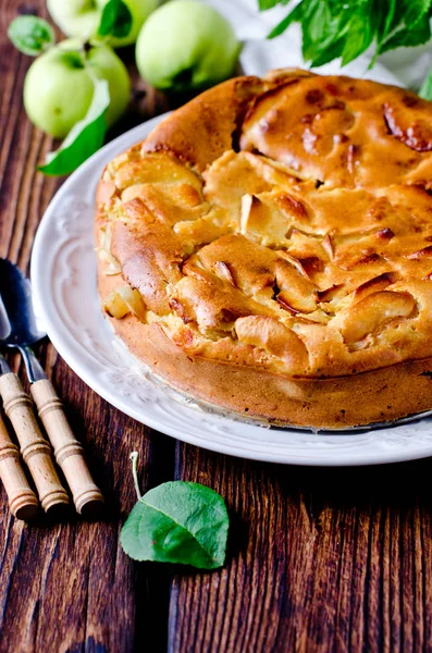 Яблочный торт на тарелке на деревянном столе — стоковое фото