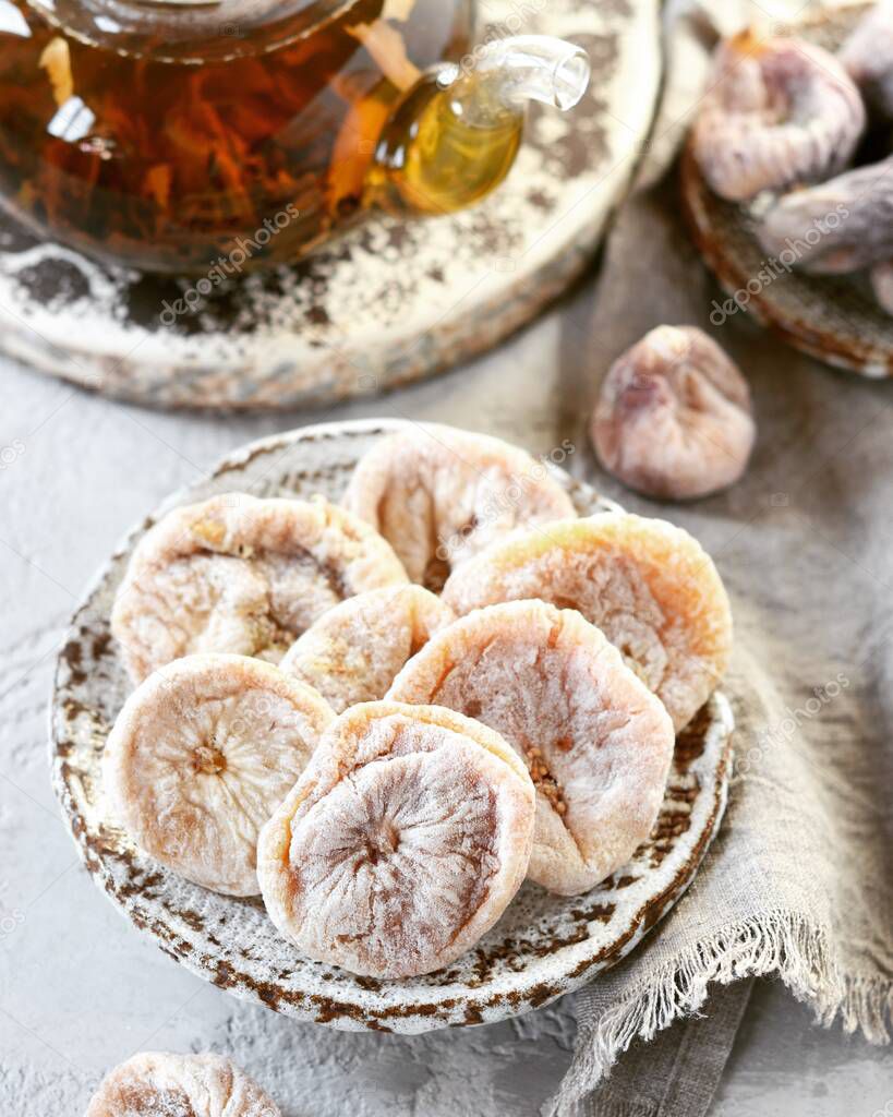Dried figs with tea in a glass teapot
