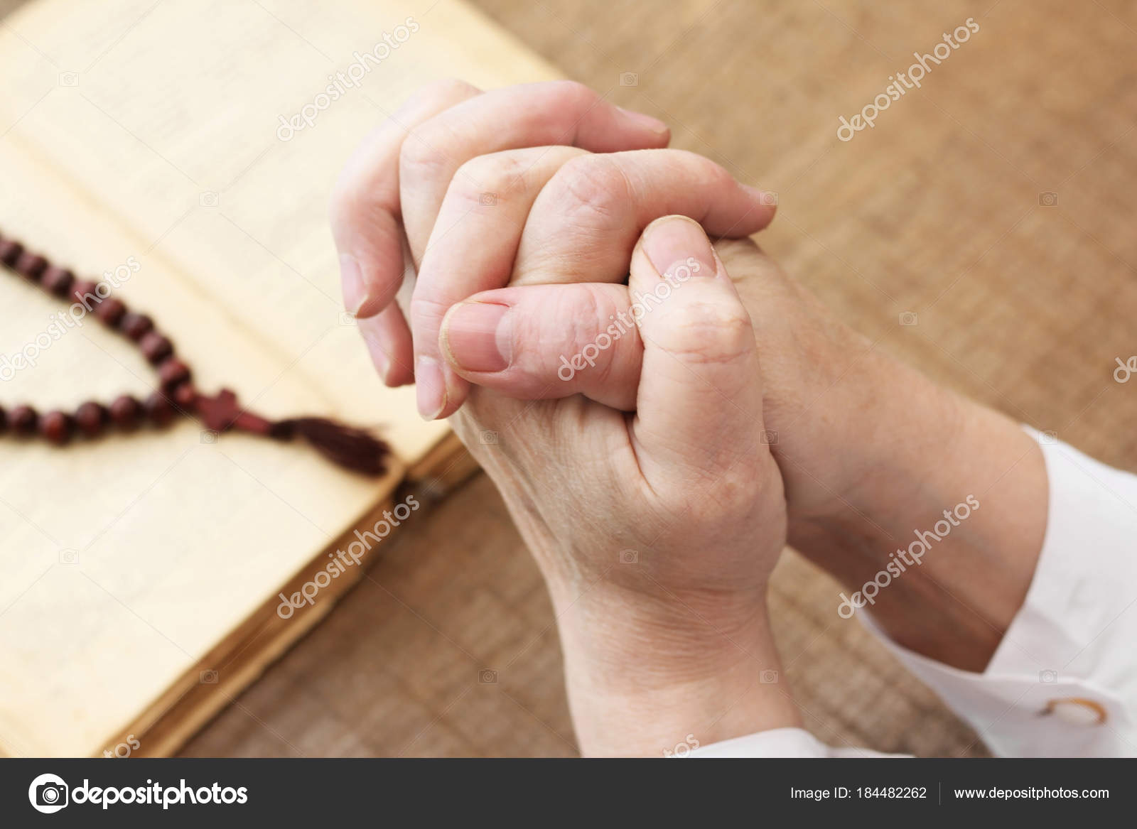 Religion. Hands of prayer with bible on the background — Stock Photo