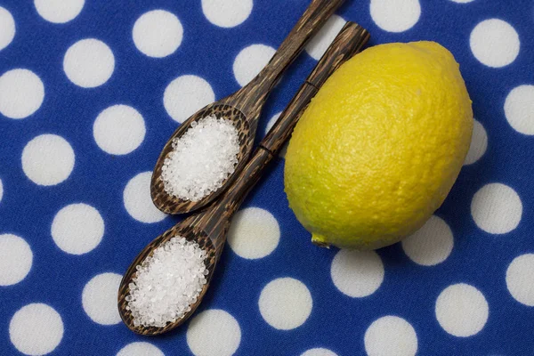 Citric acid in variegated wooden spoons, close-up