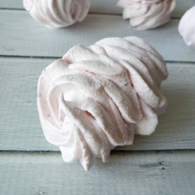 Beautiful tasty marshmallows on white wooden table