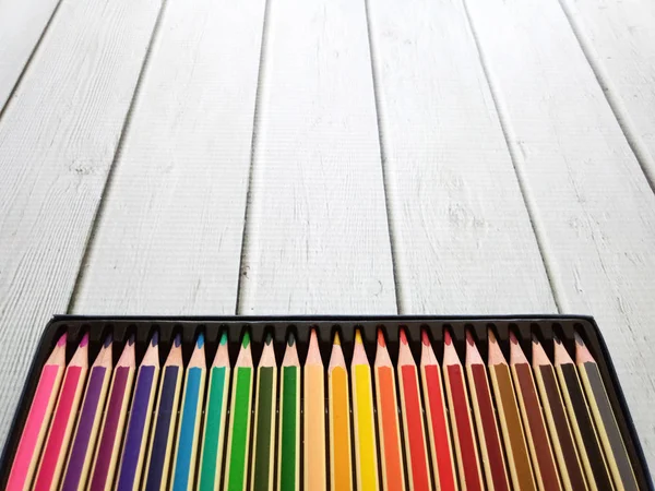 Set Of Colored Pencils In A Box On White wooden Background — Stock Photo, Image