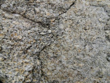 Taş gri zemin, çatlaklı taş duvar dokusu.