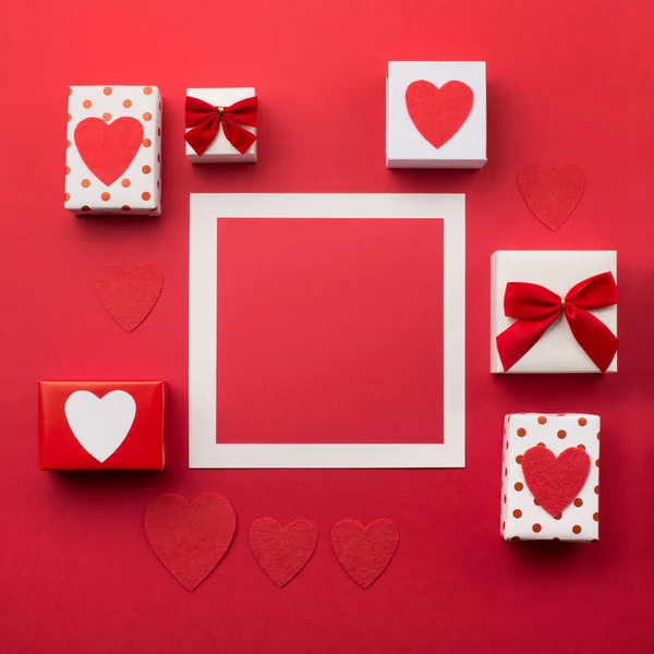 Handmade wrapped gift boxes, red hearts and candles — Stock Photo, Image