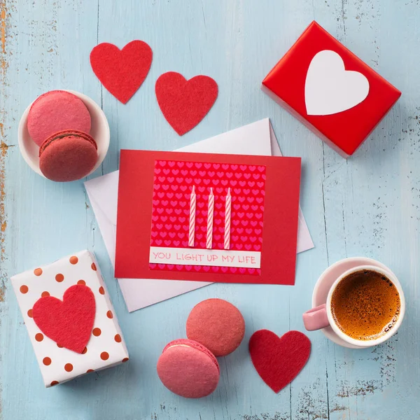 Coffee, macaroons and paper envelope with red heart