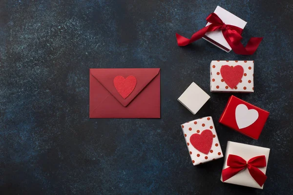 Czerwona koperta, prezenty i serca na klasycznym niebieskim tle. — Zdjęcie stockowe