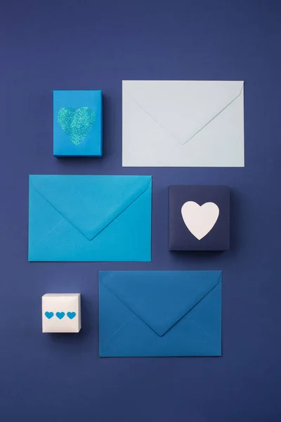 Envelopes azuis, presentes e corações brancos em azul clássico — Fotografia de Stock