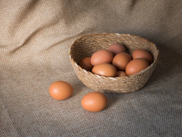 Egg in basket on brown sack cloth